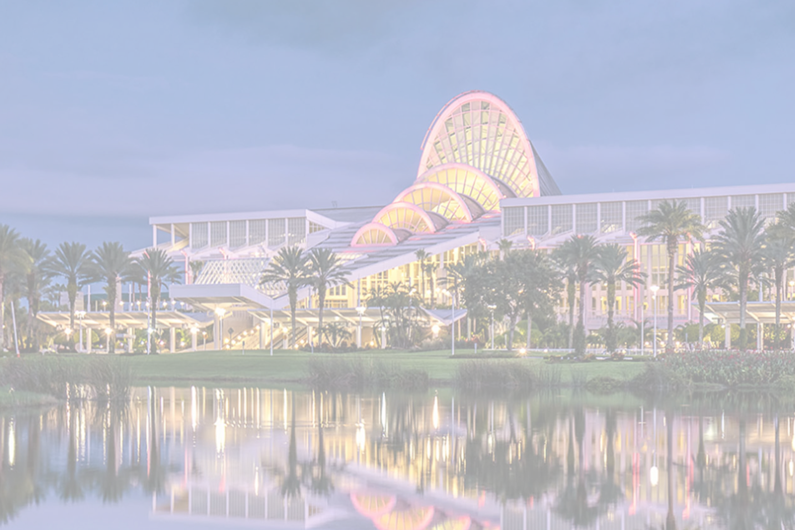 Orange County Convention Center exterior with illuminated arch and palm trees, where Smart City Networks provides technology services.