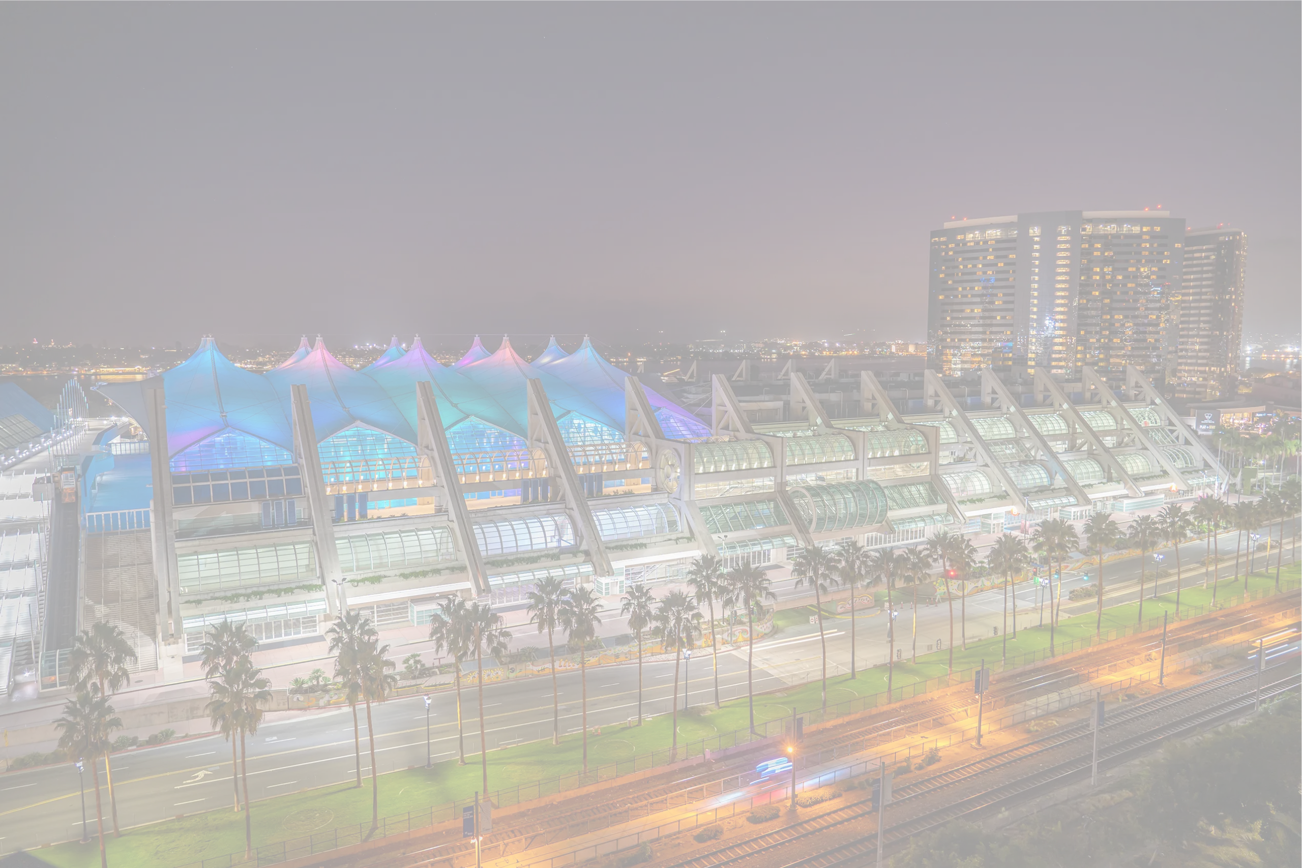 San Diego Convention Center at night with illuminated sail roof, where Smart City Networks provides connectivity and event technology services.