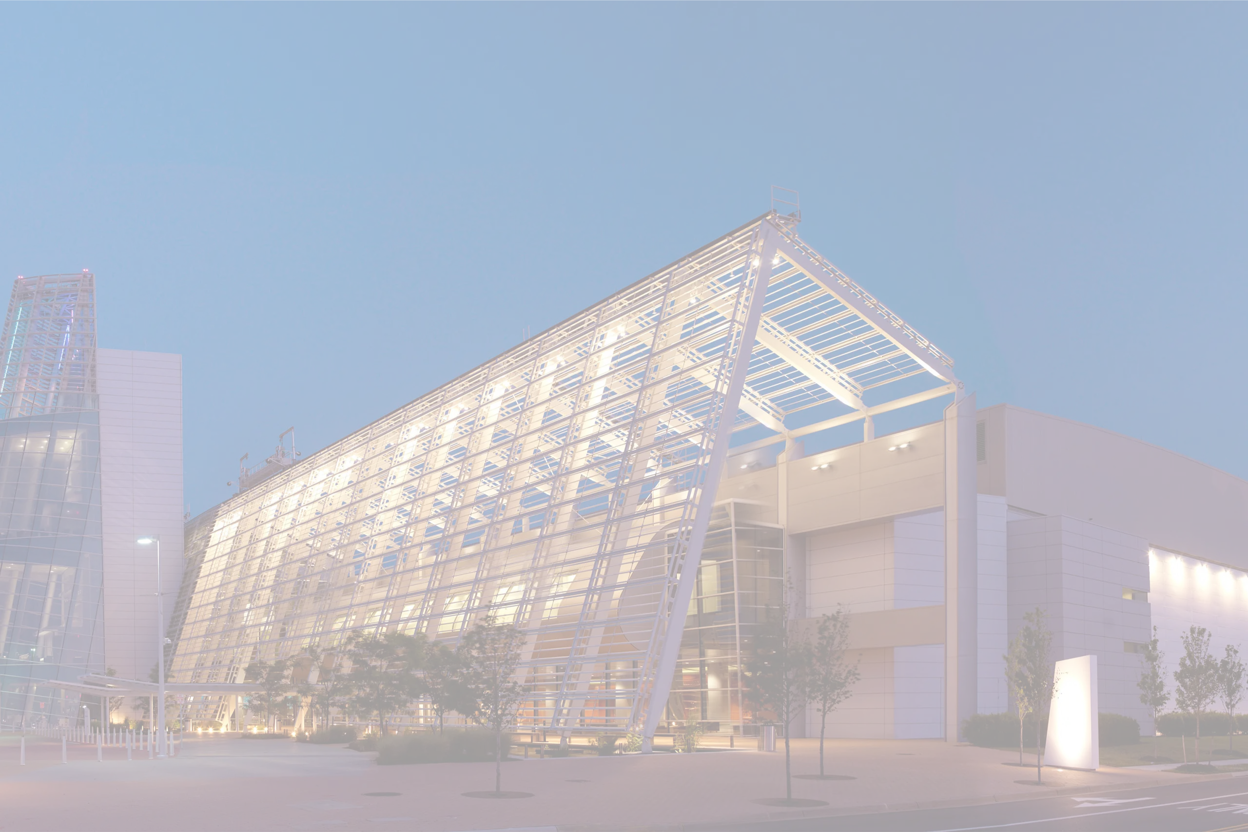 Virginia Beach Convention Center exterior with illuminated glass wing structure, supported by Smart City Networks for technology services.